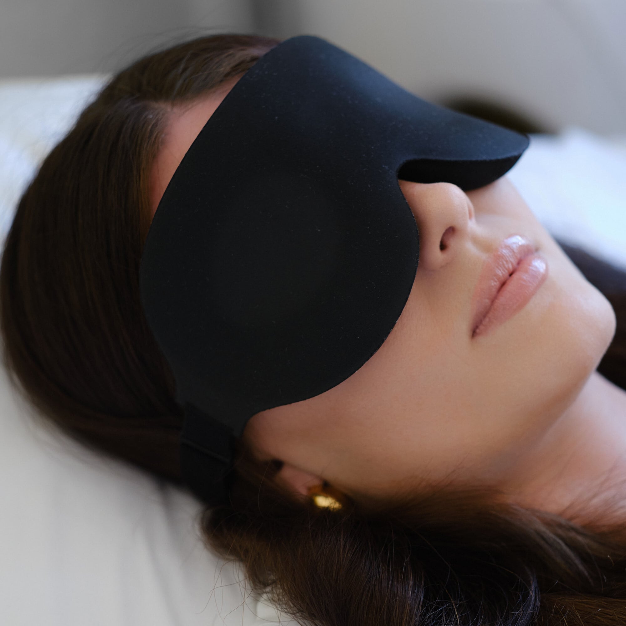 REZT sleep mask on relaxed woman