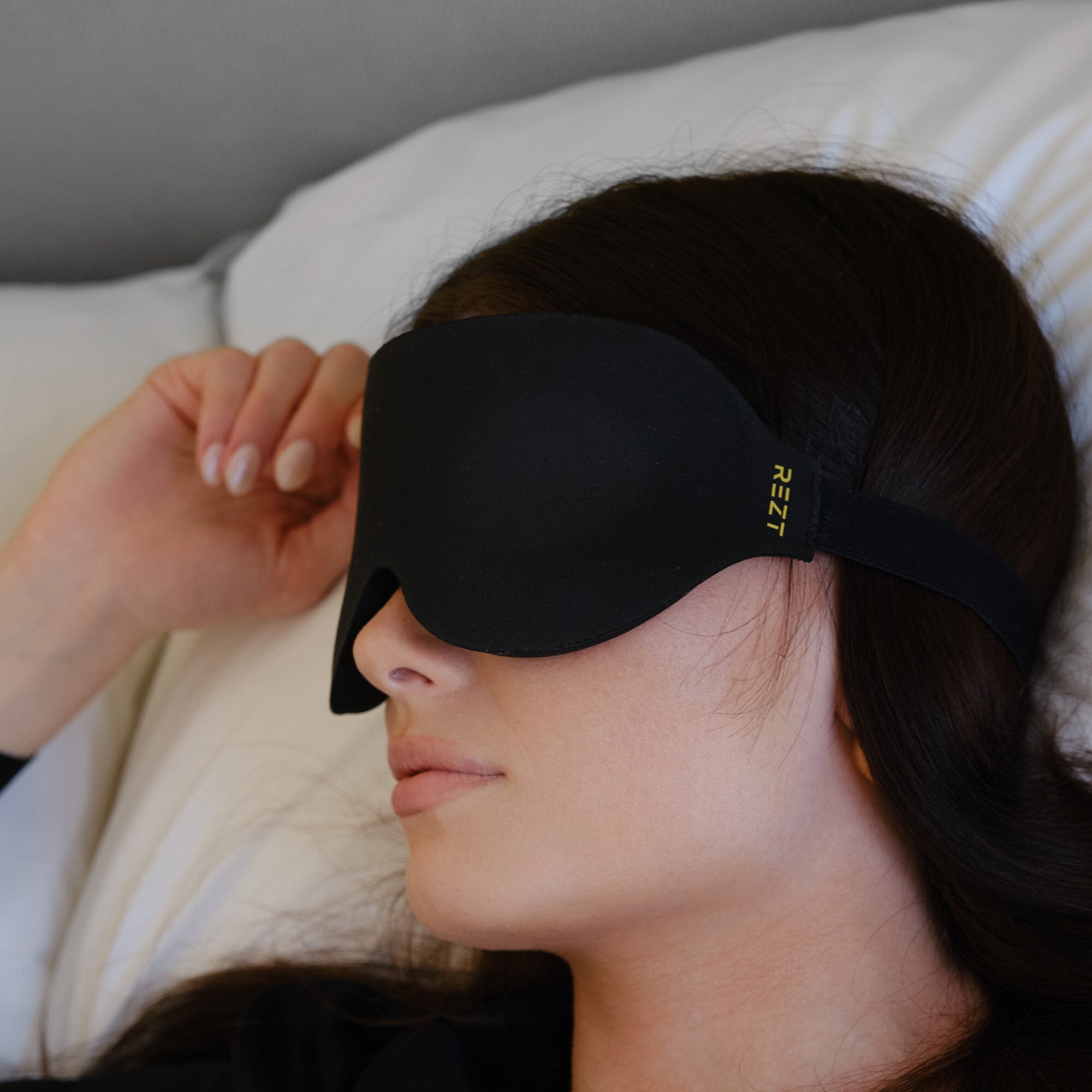 Woman resting with REZT sleep mask